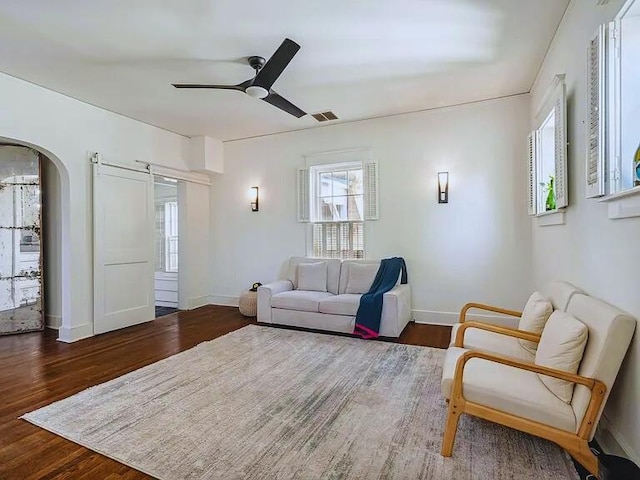 816 Charles Pl, Memphis, TN 38112 - living area with healthy amount of natural light, arched walkways, ceiling fan, and wood finished floors