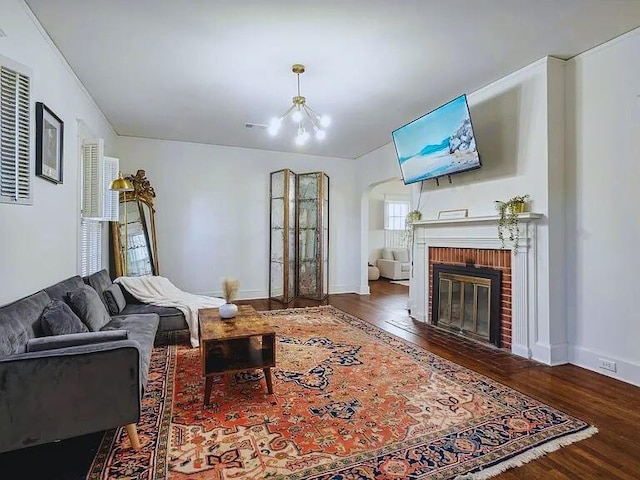 816 Charles Pl, Memphis, TN 38112 - living room with wood finished floors, arched walkways, a fireplace, and baseboards