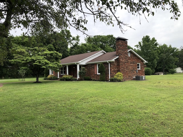 2026 Saundersville Ferry Rd, Mount Juliet, TN 37122 - view of front facade with a front yard, a chimney, brick siding, and central AC unit