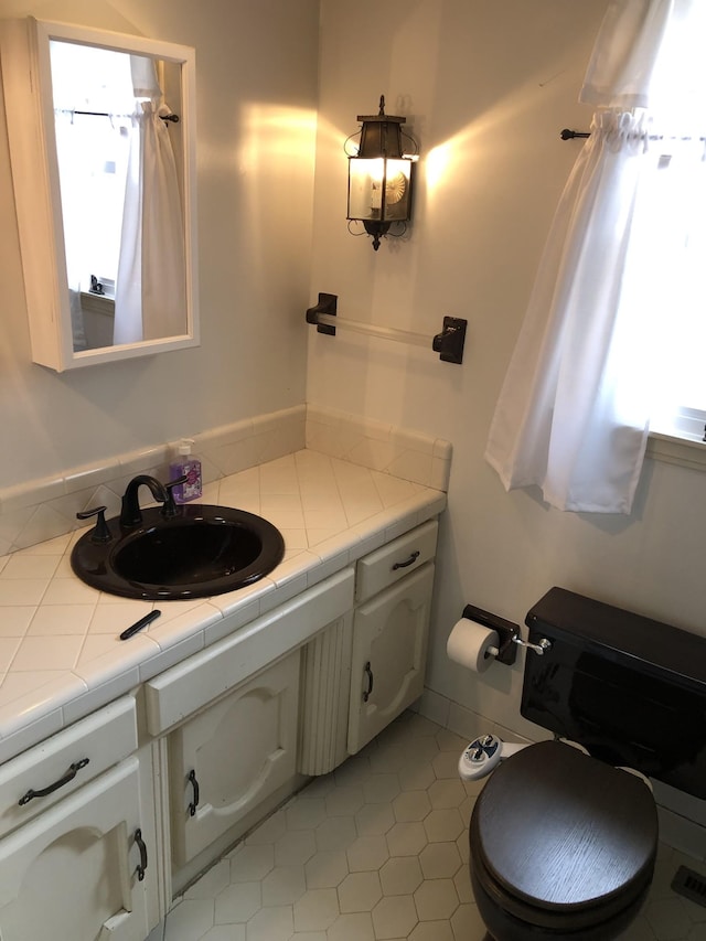2026 Saundersville Ferry Rd, Mount Juliet, TN 37122 - bathroom featuring vanity, toilet, plenty of natural light, and tile patterned floors