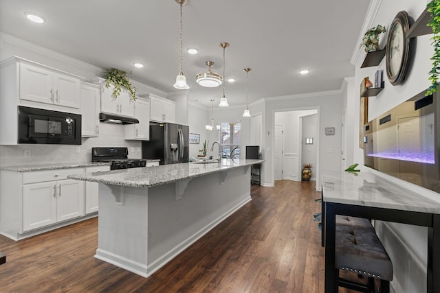 1763 Humphreys Gln, Spring Hill, TN 37174 - kitchen with black appliances, under cabinet range hood, white cabinets, dark wood-style flooring, and tasteful backsplash