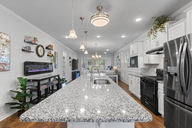 1763 Humphreys Gln, Spring Hill, TN 37174 - kitchen featuring stainless steel fridge, black gas range oven, a sink, crown molding, and a spacious island