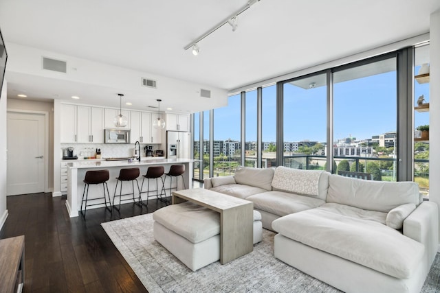 1212 Laurel St Unit 615, Nashville, TN 37203 - living area featuring dark wood-type flooring, recessed lighting, expansive windows, and track lighting