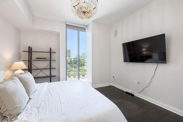 1212 Laurel St Unit 615, Nashville, TN 37203 - bedroom with dark wood-style floors, baseboards, and a chandelier