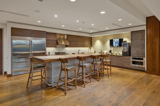 1212 Laurel St Unit 615, Nashville, TN 37203 - kitchen featuring appliances with stainless steel finishes, modern cabinets, light countertops, light wood-type flooring, and recessed lighting