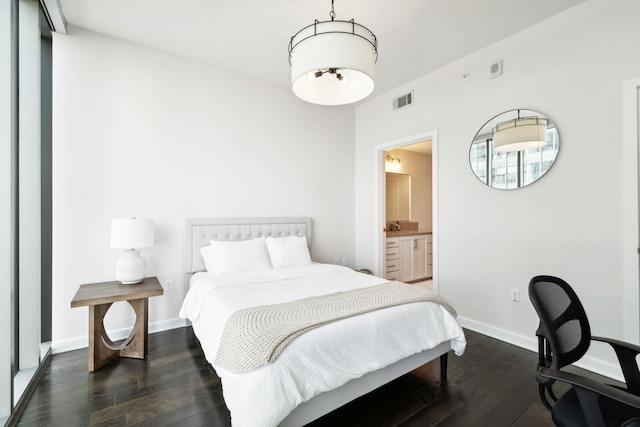 1212 Laurel St Unit 615, Nashville, TN 37203 - bedroom featuring dark wood-type flooring, baseboards, and ensuite bathroom
