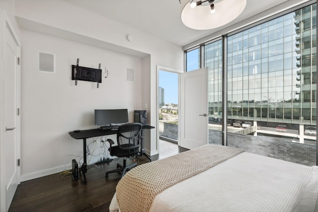 1212 Laurel St Unit 615, Nashville, TN 37203 - bedroom with wood finished floors, baseboards, an office area, and expansive windows