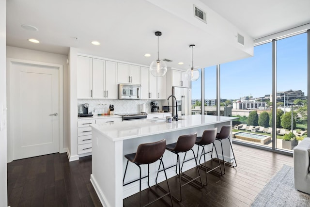 1212 Laurel St Unit 615, Nashville, TN 37203 - kitchen featuring healthy amount of natural light, fridge with ice dispenser, dark wood-type flooring, floor to ceiling windows, and recessed lighting