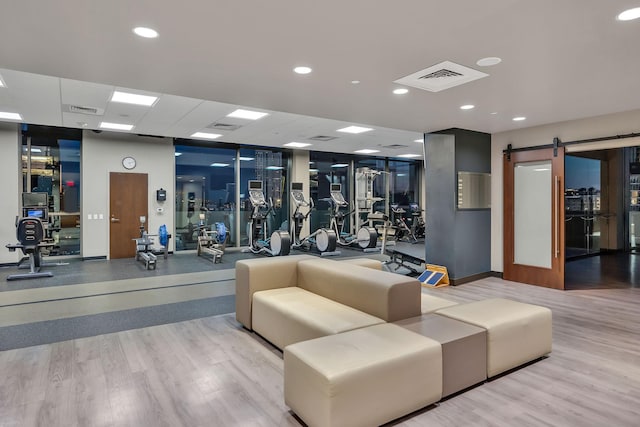 1212 Laurel St Unit 615, Nashville, TN 37203 - gym featuring a barn door, wood finished floors, and recessed lighting