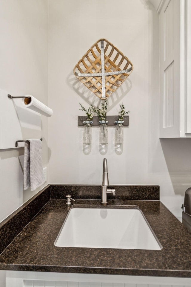 3166 Tanyard Hollow Rd, Culleoka, TN 38451 - detailed view of a sink, white cabinetry, and dark stone counters