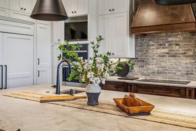 3166 Tanyard Hollow Rd, Culleoka, TN 38451 - dining area view of premium range hood, black electric cooktop, tasteful backsplash, and a sink