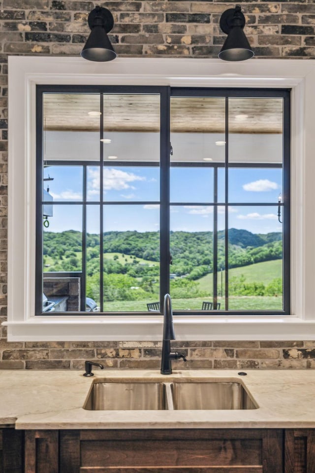 3166 Tanyard Hollow Rd, Culleoka, TN 38451 - kitchen view of a sink, brick wall, and light countertops