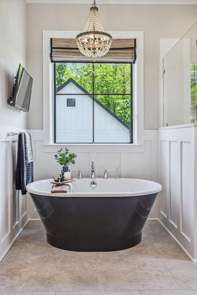 3166 Tanyard Hollow Rd, Culleoka, TN 38451 - bathroom featuring a decorative wall, a freestanding bath, plenty of natural light, a chandelier, and wainscoting