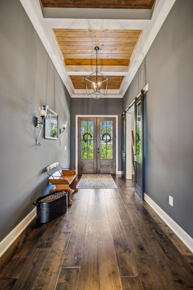 3166 Tanyard Hollow Rd, Culleoka, TN 38451 - entrance foyer with a chandelier, dark wood-style flooring, a barn door, wooden ceiling with exposed beams, and french doors