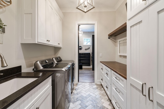 3166 Tanyard Hollow Rd, Culleoka, TN 38451 - laundry room featuring washing machine and clothes dryer, cabinet space, brick floors, and crown molding