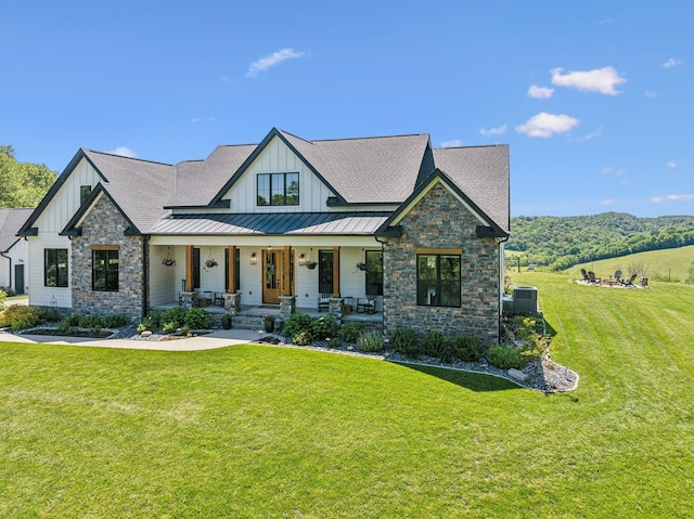 3166 Tanyard Hollow Rd, Culleoka, TN 38451 - view of front of house with board and batten siding, stone siding, and a front yard