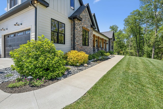 3166 Tanyard Hollow Rd, Culleoka, TN 38451 - view of side of home featuring stone siding, a yard, and board and batten siding