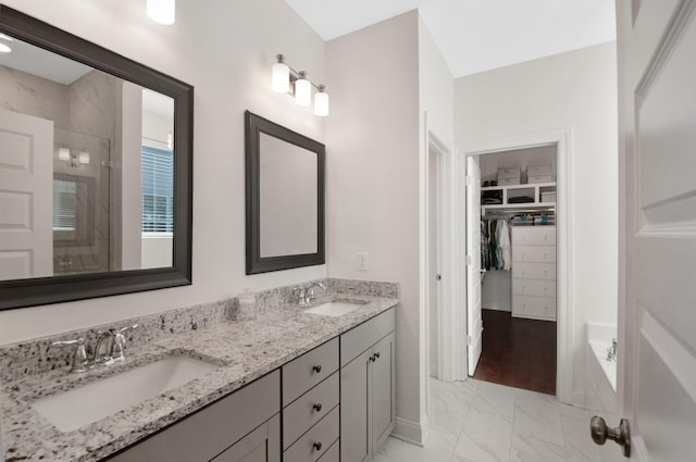 3227 Vinemont Dr, Thompsons Station, TN 37179 - full bath featuring marble finish flooring, a stall shower, double vanity, a spacious closet, and baseboards