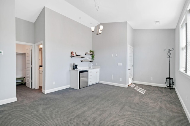3227 Vinemont Dr, Thompsons Station, TN 37179 - unfurnished living room featuring dark carpet, a chandelier, baseboards, and a high ceiling