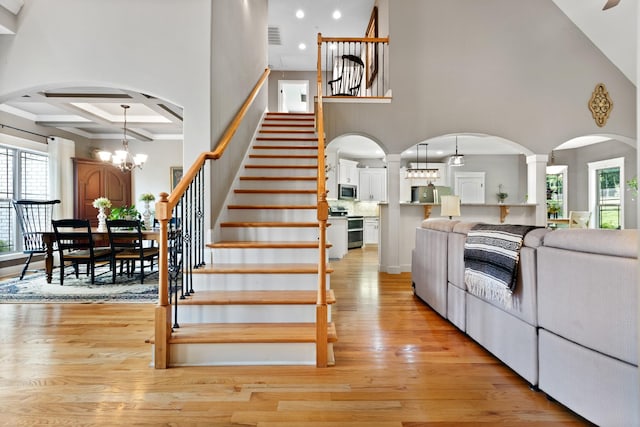 6288 Blacksmith Dr, Pleasant View, TN 37146 - stairway with a high ceiling, arched walkways, healthy amount of natural light, coffered ceiling, and wood finished floors