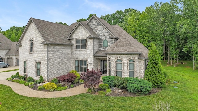 6288 Blacksmith Dr, Pleasant View, TN 37146 - french country style house featuring a front lawn, brick siding, and a shingled roof