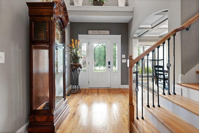 6288 Blacksmith Dr, Pleasant View, TN 37146 - foyer entrance featuring stairs, coffered ceiling, arched walkways, baseboards, and wood finished floors