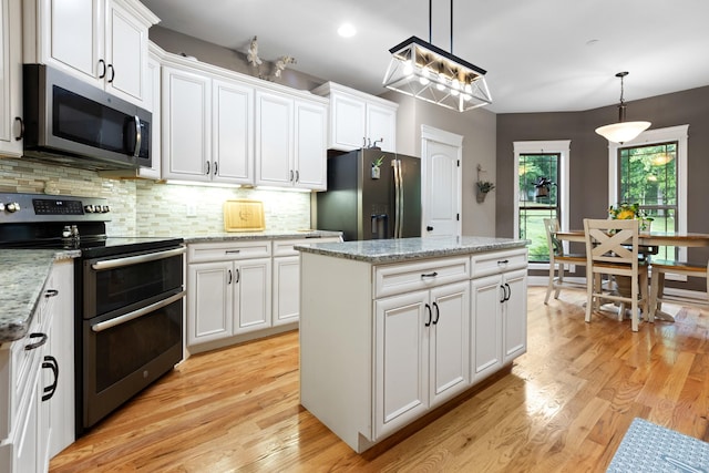 6288 Blacksmith Dr, Pleasant View, TN 37146 - kitchen with appliances with stainless steel finishes, light wood-style floors, white cabinetry, backsplash, and recessed lighting