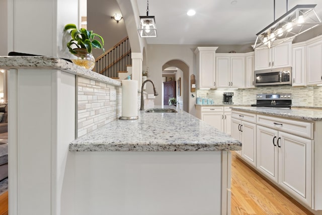 6288 Blacksmith Dr, Pleasant View, TN 37146 - kitchen with stainless steel microwave, a sink, electric range oven, and backsplash