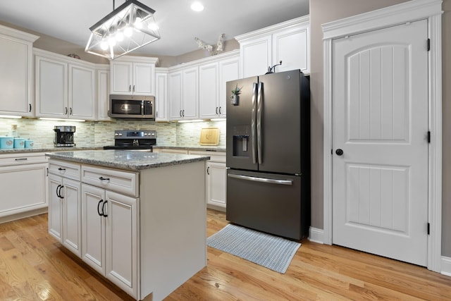 6288 Blacksmith Dr, Pleasant View, TN 37146 - kitchen with stainless steel appliances, white cabinetry, decorative backsplash, and light wood-style floors