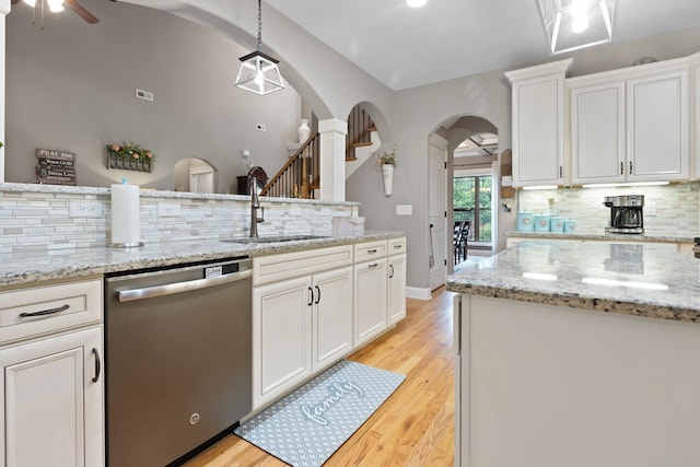 6288 Blacksmith Dr, Pleasant View, TN 37146 - kitchen with dishwasher, a sink, arched walkways, a ceiling fan, and tasteful backsplash