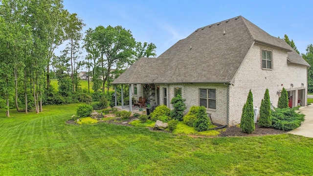 6288 Blacksmith Dr, Pleasant View, TN 37146 - view of side of property with a lawn, brick siding, roof with shingles, a patio area, and an attached garage