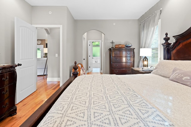 6288 Blacksmith Dr, Pleasant View, TN 37146 - bedroom featuring arched walkways, wood finished floors, and baseboards