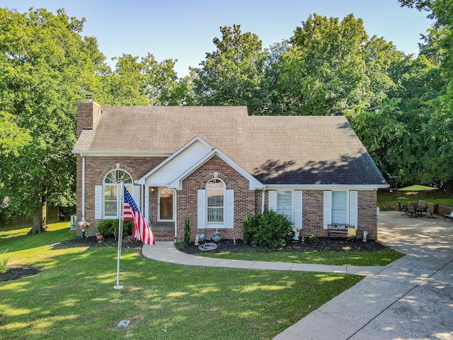 530 David Ave, Lewisburg, TN 37091 - view of front of house featuring brick siding, a chimney, a front lawn, and roof with shingles