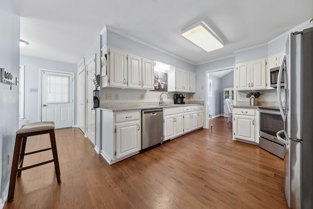 530 David Ave, Lewisburg, TN 37091 - kitchen with appliances with stainless steel finishes, white cabinets, dark wood finished floors, ornamental molding, and light stone countertops