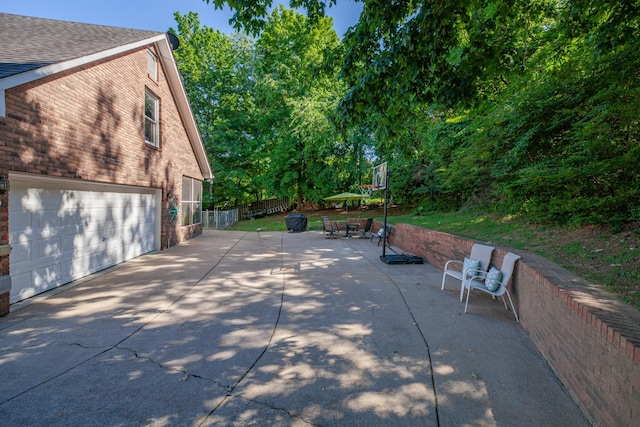 530 David Ave, Lewisburg, TN 37091 - view of property exterior with brick siding, a shingled roof, driveway, a patio area, and an attached garage
