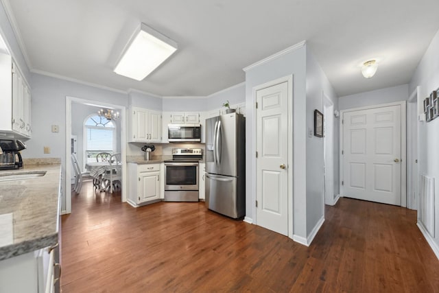 530 David Ave, Lewisburg, TN 37091 - kitchen featuring appliances with stainless steel finishes, white cabinetry, dark wood-style floors, a chandelier, and crown molding