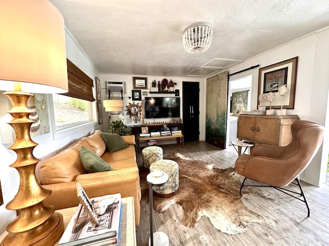 645 Attaway Ln, Bath Springs, TN 38311 - living room with wood finished floors, a textured ceiling, and a chandelier