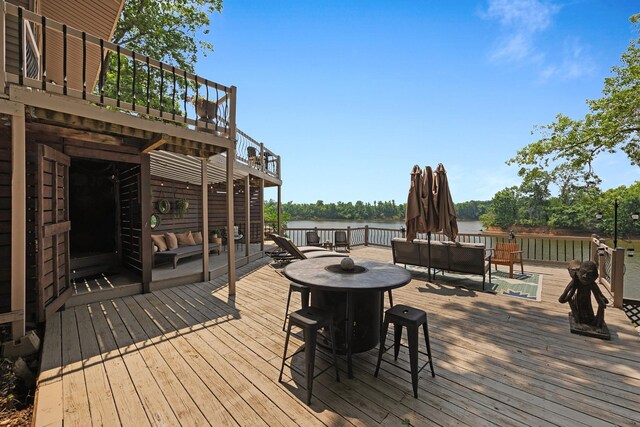 645 Attaway Ln, Bath Springs, TN 38311 - deck with outdoor lounge area, outdoor dining space, and a water view