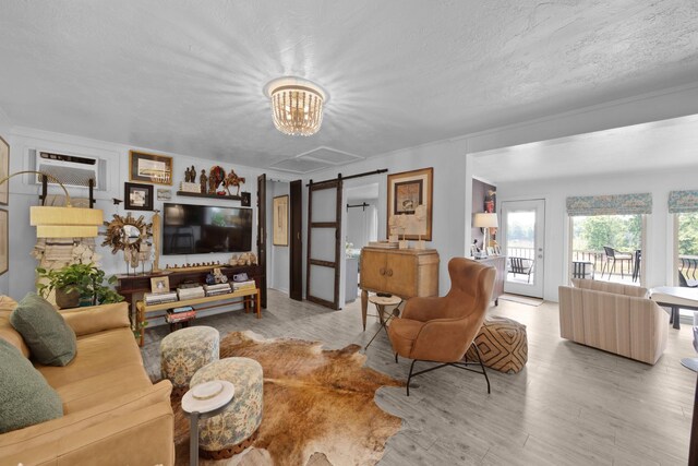 645 Attaway Ln, Bath Springs, TN 38311 - living area featuring a barn door, a chandelier, and wood finished floors