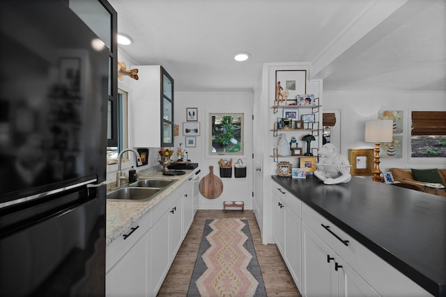 645 Attaway Ln, Bath Springs, TN 38311 - kitchen featuring freestanding refrigerator, a sink, white cabinetry, and healthy amount of natural light