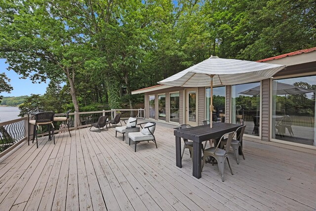 645 Attaway Ln, Bath Springs, TN 38311 - deck with outdoor dining space, an outdoor living space, and view of scattered trees