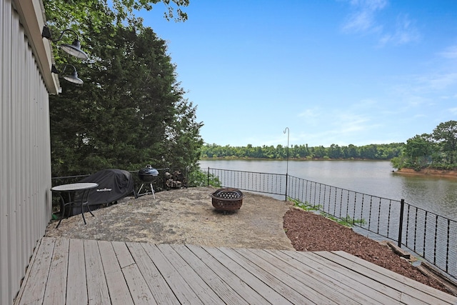 645 Attaway Ln, Bath Springs, TN 38311 - deck featuring a fire pit, a water view, and area for grilling