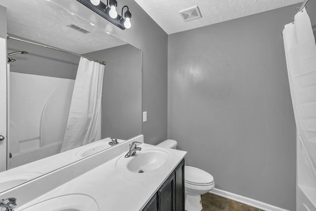 911 Keepsake Diamond Ln, Murfreesboro, TN 37128 - bathroom featuring a textured ceiling, double vanity, toilet, and baseboards