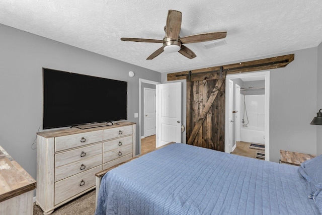 911 Keepsake Diamond Ln, Murfreesboro, TN 37128 - bedroom featuring a barn door, a textured ceiling, a ceiling fan, and connected bathroom
