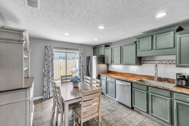 911 Keepsake Diamond Ln, Murfreesboro, TN 37128 - kitchen with green cabinets, stainless steel appliances, a sink, a textured ceiling, and recessed lighting
