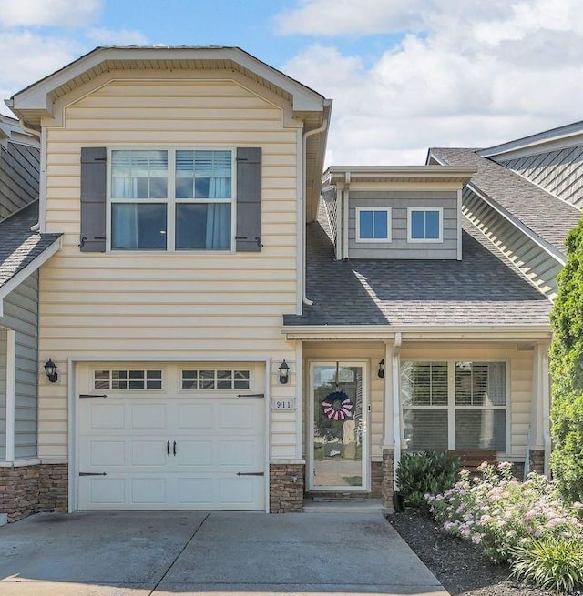 911 Keepsake Diamond Ln, Murfreesboro, TN 37128 - view of front facade with driveway, stone siding, roof with shingles, and a garage