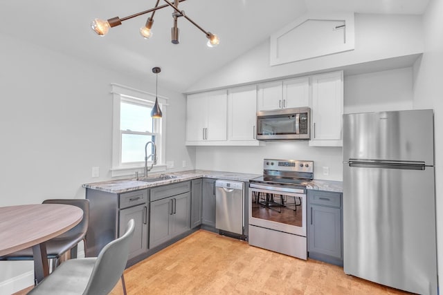 6416 Edsel Dr, Nashville, TN 37209 - kitchen with appliances with stainless steel finishes, a sink, lofted ceiling, gray cabinets, and light stone counters