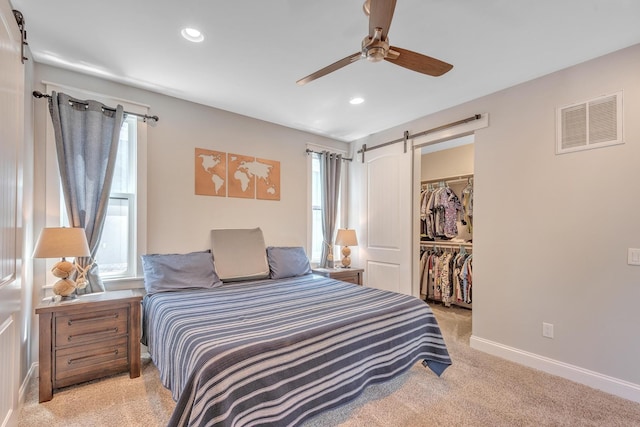 6416 Edsel Dr, Nashville, TN 37209 - bedroom with a barn door, light carpet, a spacious closet, a closet, and recessed lighting