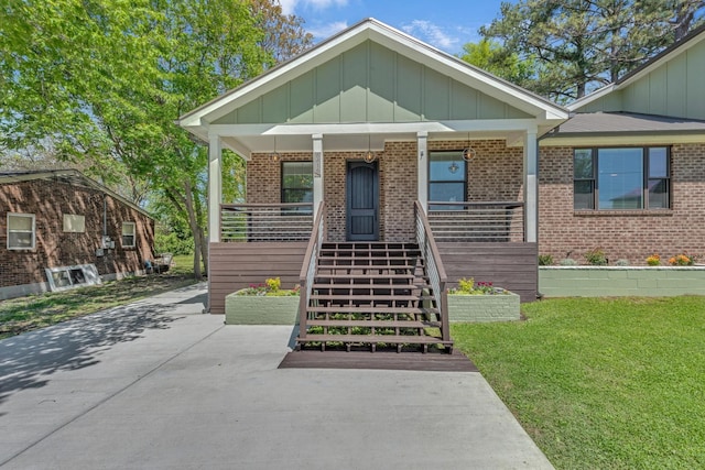 6416 Edsel Dr, Nashville, TN 37209 - view of front facade featuring brick siding, board and batten siding, covered porch, and stairway