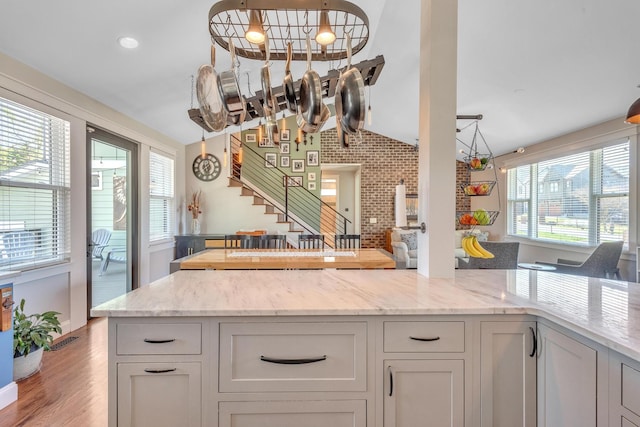 6416 Edsel Dr, Nashville, TN 37209 - kitchen with a chandelier, healthy amount of natural light, lofted ceiling, and light stone counters